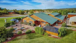 A lodge with multiple wooden buildings, a swimming pool, and a well-maintained lawn. - Zion Views-Sunset Cabin+Resort Access (Orderville)