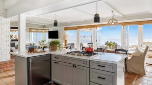 A spacious kitchen with a large island, modern appliances, and a view of the ocean. - Unbeatable Beachfront Bliss w/ Ocean Views, Luxe Interiors & Patio Beach Road (Dana Point)
