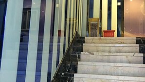 A marble staircase with glass railings leading to a door. - Jiaqi Hotel (Shanghai)