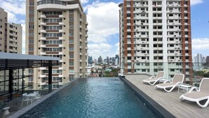 A rooftop pool with lounge chairs and a city view. - Modern and cozy apartment in the heart of Panama City, ideal for business travelers and digital nomads. Pool, gym, and coworking space available, with valet parking offered as an optional service. (Panamá)