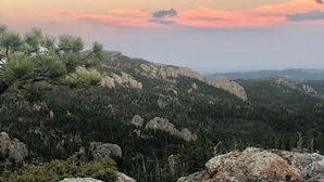 Un paysage montagneux caractérisé par une forêt dense et des affleurements rocheux.