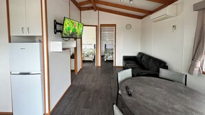 Hytte – deluxe | Oppholdsområde | Flatskjerm-TV