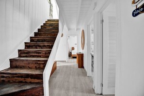Staircase leads to an upper floor with a sign indicating 'place'.