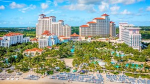 A resort with multiple high-rise buildings, a beachfront, and a pool area.
