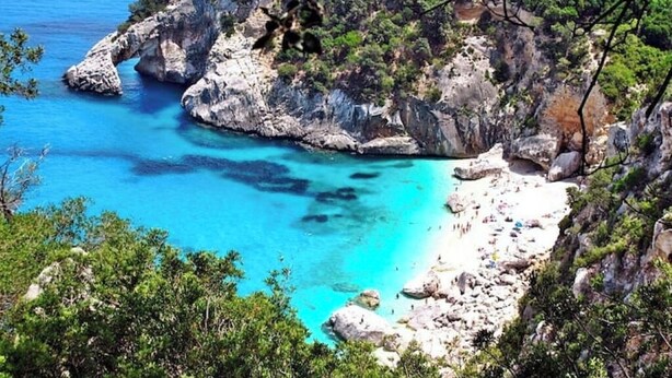 A coastal landscape with rocky cliffs and clear turquoise waters. - An oasis of relaxation, in a dreamy sea. Beautiful view of the sea mountain and village  (Cala Gonone)