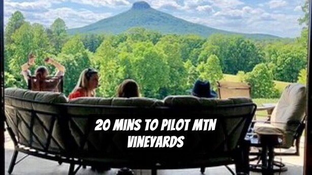 A view from a covered patio with a mountain in the background.