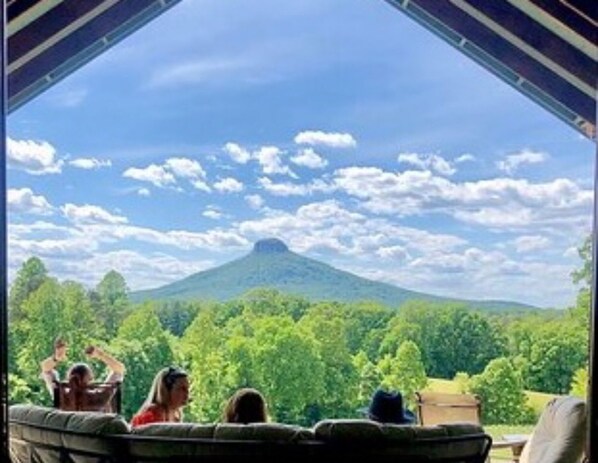 A view from a covered patio with a mountain in the background. - The Farmhouse. Vintage 3-bedroom with WiFi. Mt Airy outskirts. Vineyards nearby. (Mount Airy)