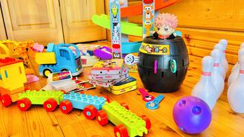 Children's play area features a train set, toy car, bowling alley, and puzzles.