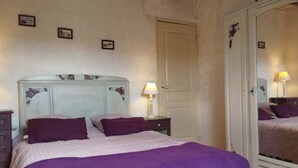 A bedroom with a bed, a nightstand, a dresser, and a mirror. - Potager country house in the heart of the Charolais in southern Burgundy (Baron)