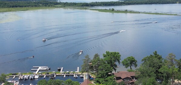 A marina with boats, docks, and a dockside area with buildings and trees. - Sunset Cove Resort (Cass Lake)