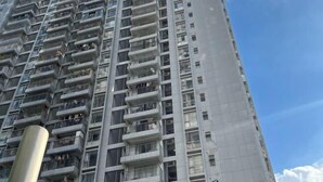 A high-rise residential building with multiple balconies and a clear sky. - Pinwu Apartment (Shenzhen)