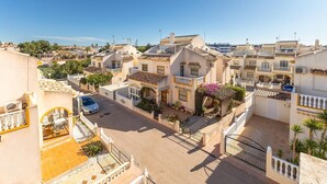 A residential area with terracotta-tiled roofs, balconies, and a paved street. - 2 bedroom stunning home in La Zenia (La Zenia)