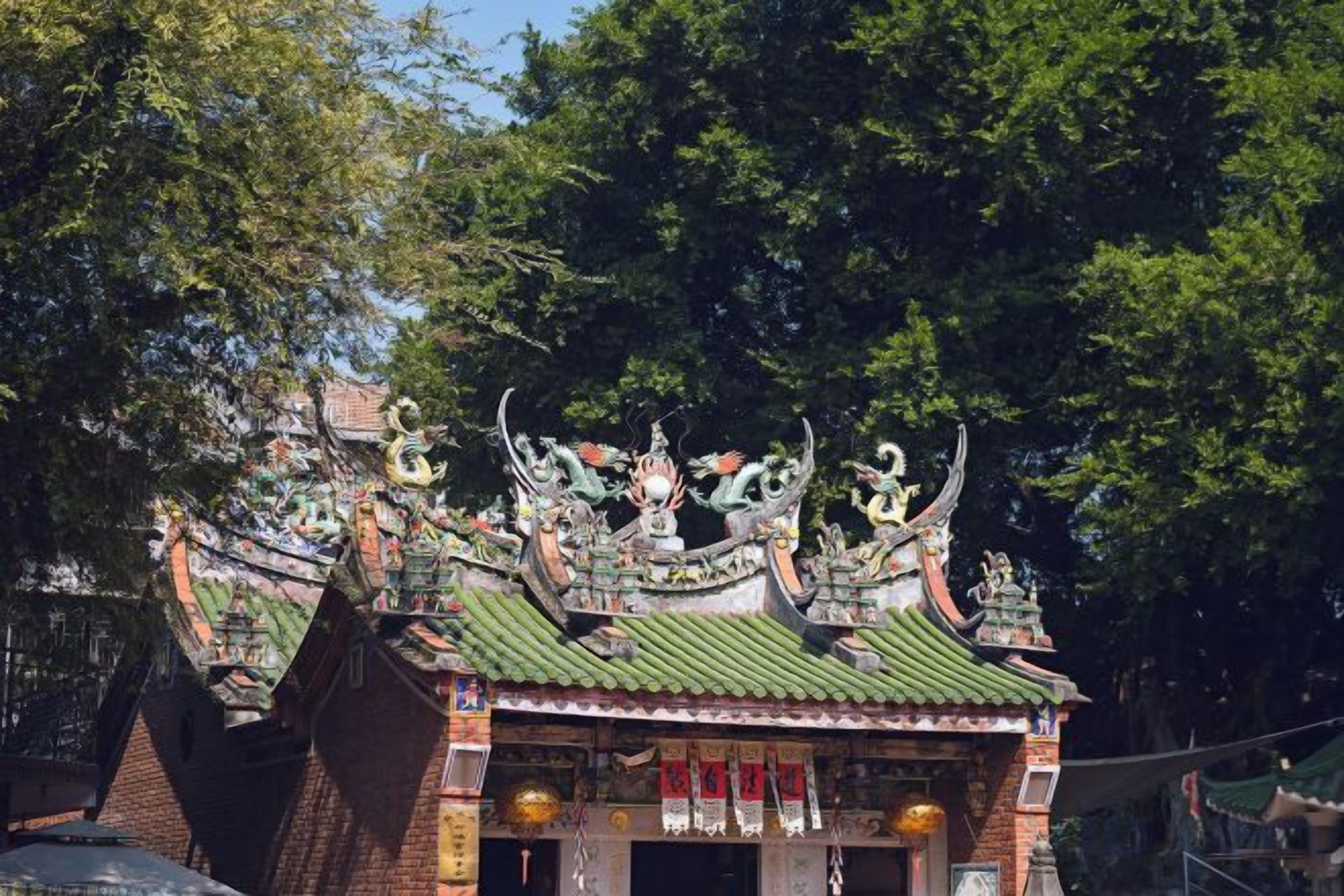 A traditional building with ornate roof decorations and a brick facade.