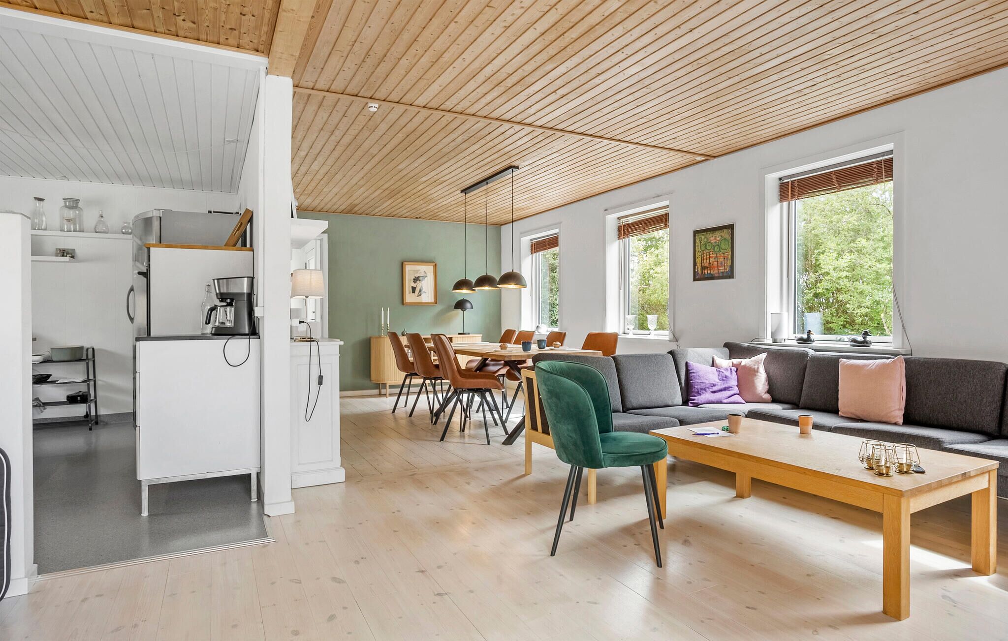 A modern interior with a kitchen, dining area, and living space.