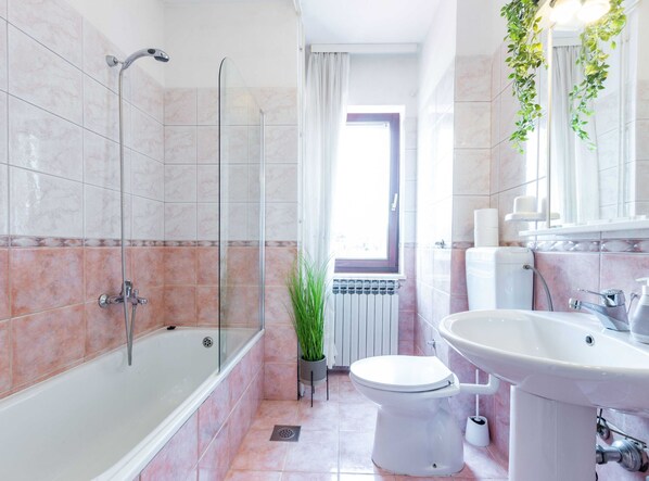 A modern bathroom with a glass-enclosed shower, a toilet, a sink, and a radiator. - Zadar Lavish and Luxurious Apartment With Private Pool (Zadar)