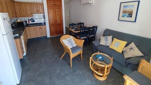 A compact living space with a kitchen, dining area, and seating area.