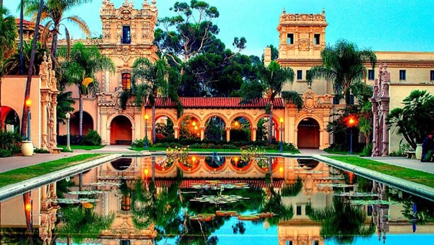 A historic building with ornate architecture, a central courtyard with a reflective pool, and palm trees. - Stay in the Heart of Hillcrest! San Diego (San Diego)