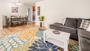 A living room with a gray sofa, a white coffee table, and a colorful rug. - Stay in the Heart of Hillcrest! San Diego (San Diego)
