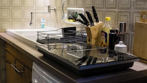 A kitchen with a dishwasher, sink, and various utensils. - La Casa Borgo Ischia di Castro (Ischia di Castro)