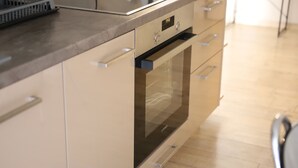 A kitchen with a built-in oven and a stainless steel countertop. - Patisia Metro Station 2 bdrm apartment by MPS (Athina)