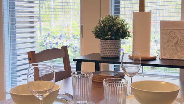 A dining table set with bowls, glasses, and a plant. - Brand-new studio surrounded by forest, All New Cozy Home in Turku (Turku)