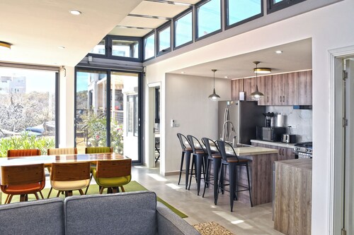 Unique modern repurposed shipping container home. 250mb+  WiFi with Starlink backup.  Lounge in a hammock or day bed on one deck or teak furniture w/ firepit on the other.  Store gear in a large secure guest locker.  Free use of SUPs and beach toys.