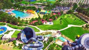 A water park with multiple water slides and a large circular water feature. - Entire spectacular lake and ocean view holiday house (Lake Heights)