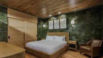 A bedroom with a wooden bed, a nightstand, a chair, and a wardrobe.