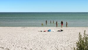 A sandy beach with a clear view of the ocean.