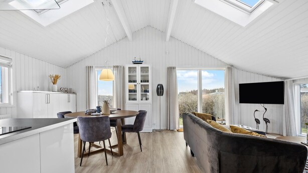 A modern interior with a dining area, kitchen, and living space.