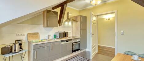 Fridge, stovetop, dishwasher, coffee/tea maker