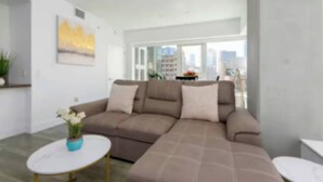 A modern living room with a brown sectional sofa, a white coffee table, and a painting on the wall. - City Skyline Views 3Bed Apt with Rooftop Pool, Spa,& Rooftop deck (Los Angeles)
