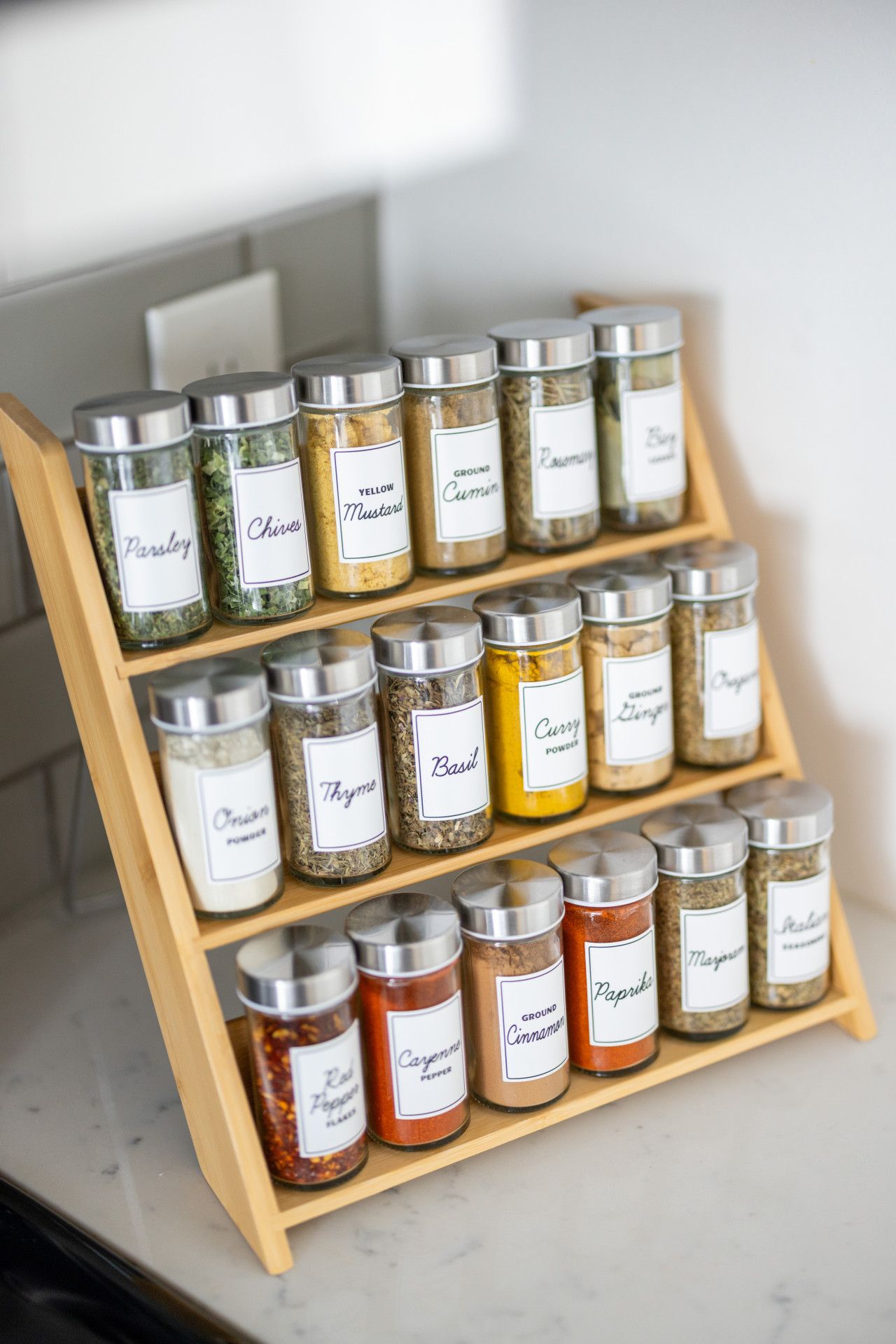 A spice rack with various labeled containers.