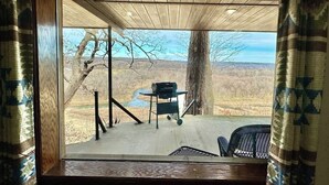 A wooden deck with a table and chairs, overlooking a scenic landscape. - Buffalo Cabin Gorgeous Illinois River view (Tahlequah)