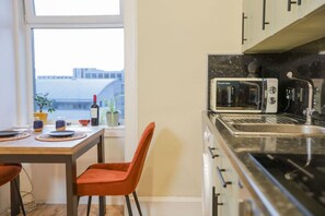 Microwave, stovetop, toaster, dining tables