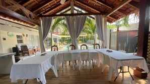 A covered outdoor dining area with a pool in the background. - Rancho Matnik a Hidden Paradise (La Paz)