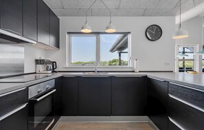 Fridge, stovetop, dishwasher, coffee/tea maker