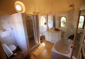 Enjoy a refreshing shower or soak in the bathtub in this beautifully tiled bathroom.