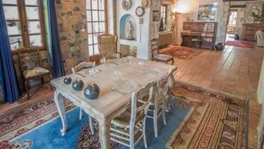 A dining area with a wooden table set for four, surrounded by chairs. - Beautiful land house in Noves near Avignon, private pool, pets allowed (1). (NOVES)