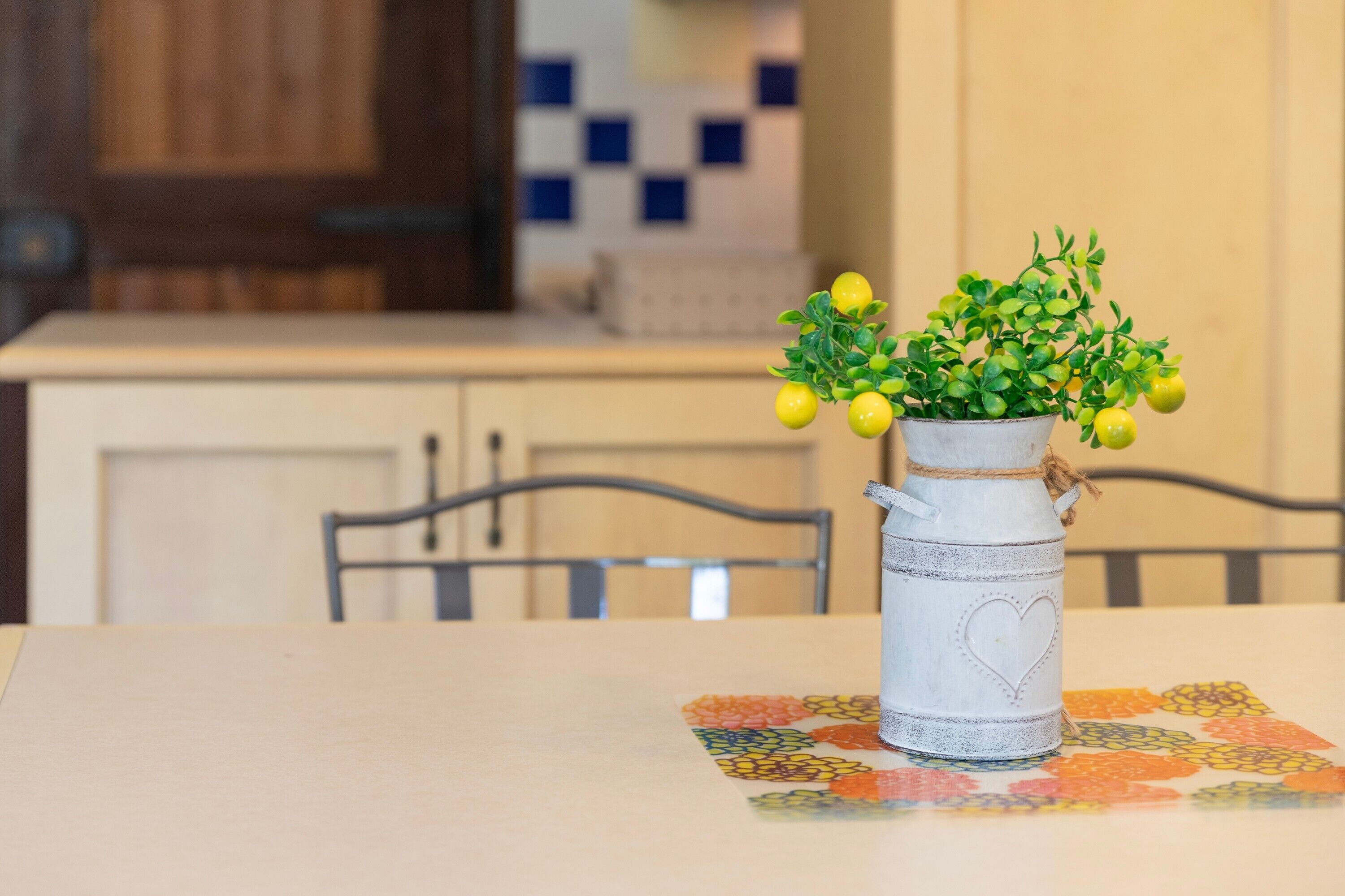 A table with a potted plant and a table runner.