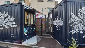 A gated entrance with a colorful mural and decorative elements.