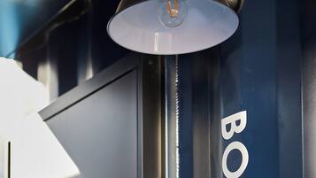 A modern industrial-style room with a large, dark blue wall and a metallic structure labeled "BOHO".