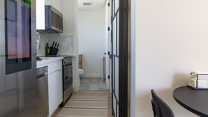 A modern kitchen with stainless steel appliances, a microwave, and a built-in oven.