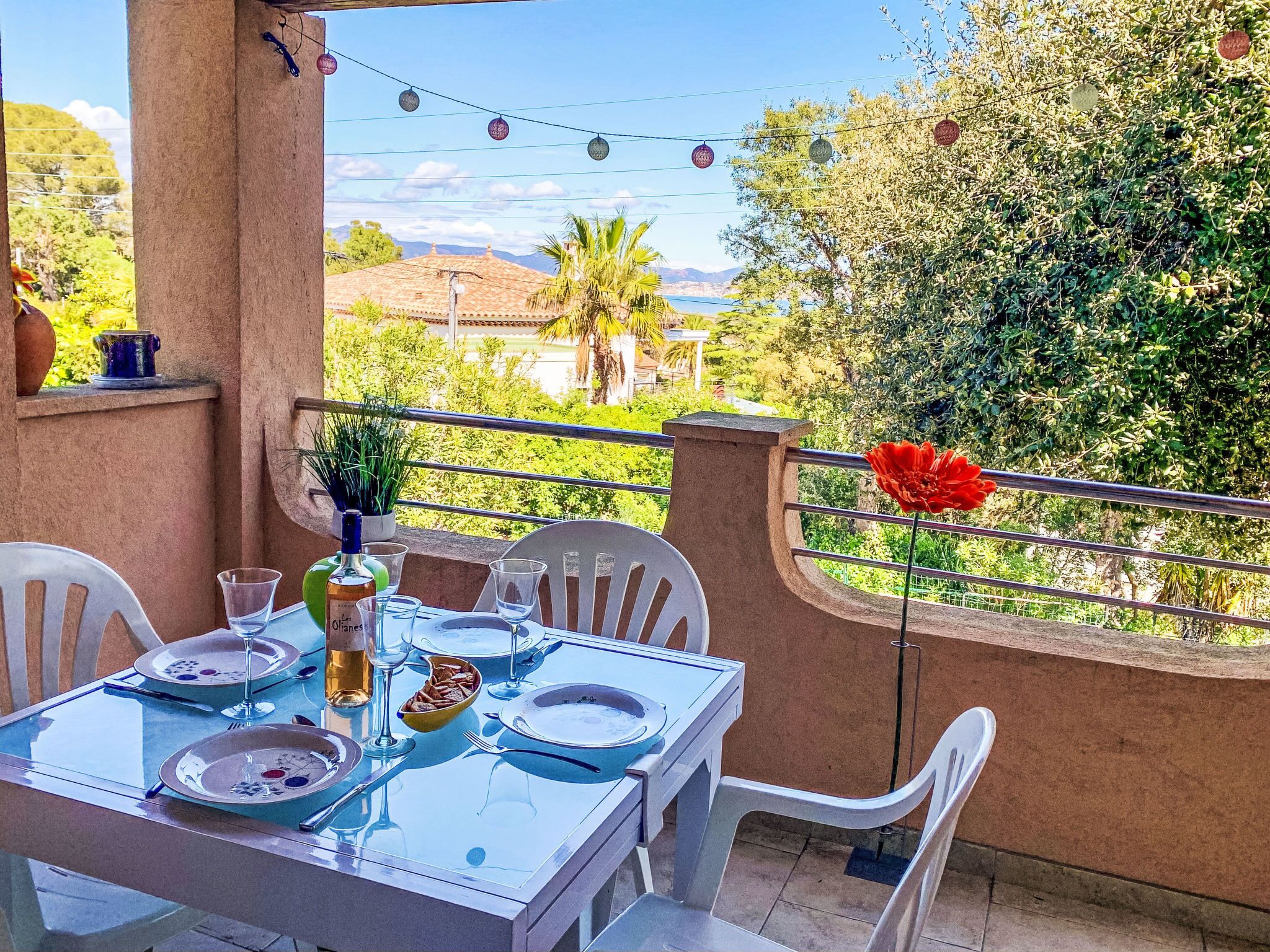 A table set for dining with a view of the countryside.