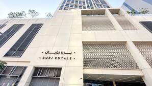 A modern building with a prominent sign reading "BURJ ROYALE". - Spectacular Burj View 2BR Luxury (Dubai)