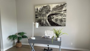 A modern office space with a desk, chair, and potted plants. - Prime NW Austin TX near Domain, Apple, Oracle, high tech corridor upgraded home! (Austin)