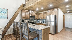 A kitchen with wooden cabinets, a granite countertop, and stainless steel appliances. - Large Lake Penthouse Condo, 3 bdrm, sleeps 14- Resort Amenities Galore, Ticket & Golf Deals (Branson)