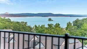 A view of a lake with a small island, surrounded by trees and hills. - Large Lake Penthouse Condo, 3 bdrm, sleeps 14- Resort Amenities Galore, Ticket & Golf Deals (Branson)