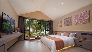 A modern hotel room with a large bed, a desk, and a TV displaying a scenic view. - Yun Guan Shunde Renjia Resort Hotel (Xishuangbanna Dai)