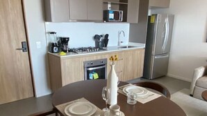 A modern kitchen with a dining area.